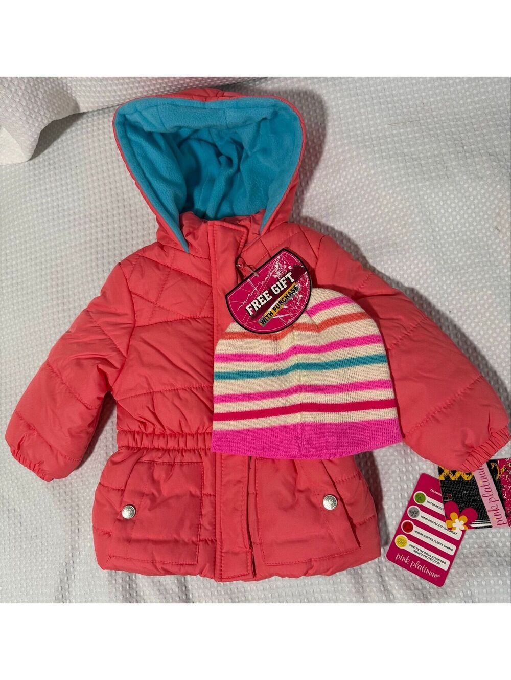 2T girls puffer jacket and a striped beanie hat